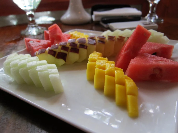 melon and pineapple slices are cut into squares