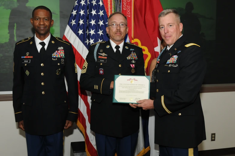 a couple of men standing in front of two flags