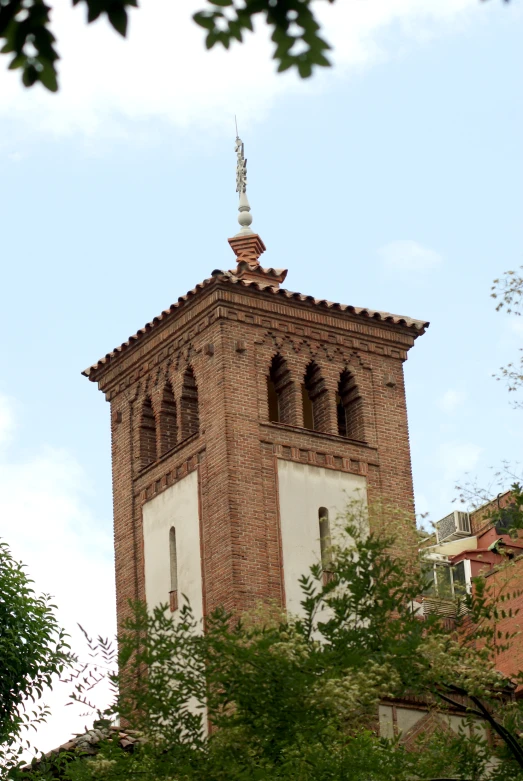 a clock tower on top of a building, surrounded by trees