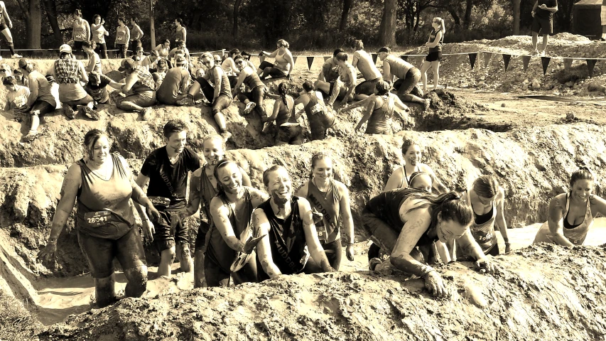 black and white pograph of people in front of sand mounds