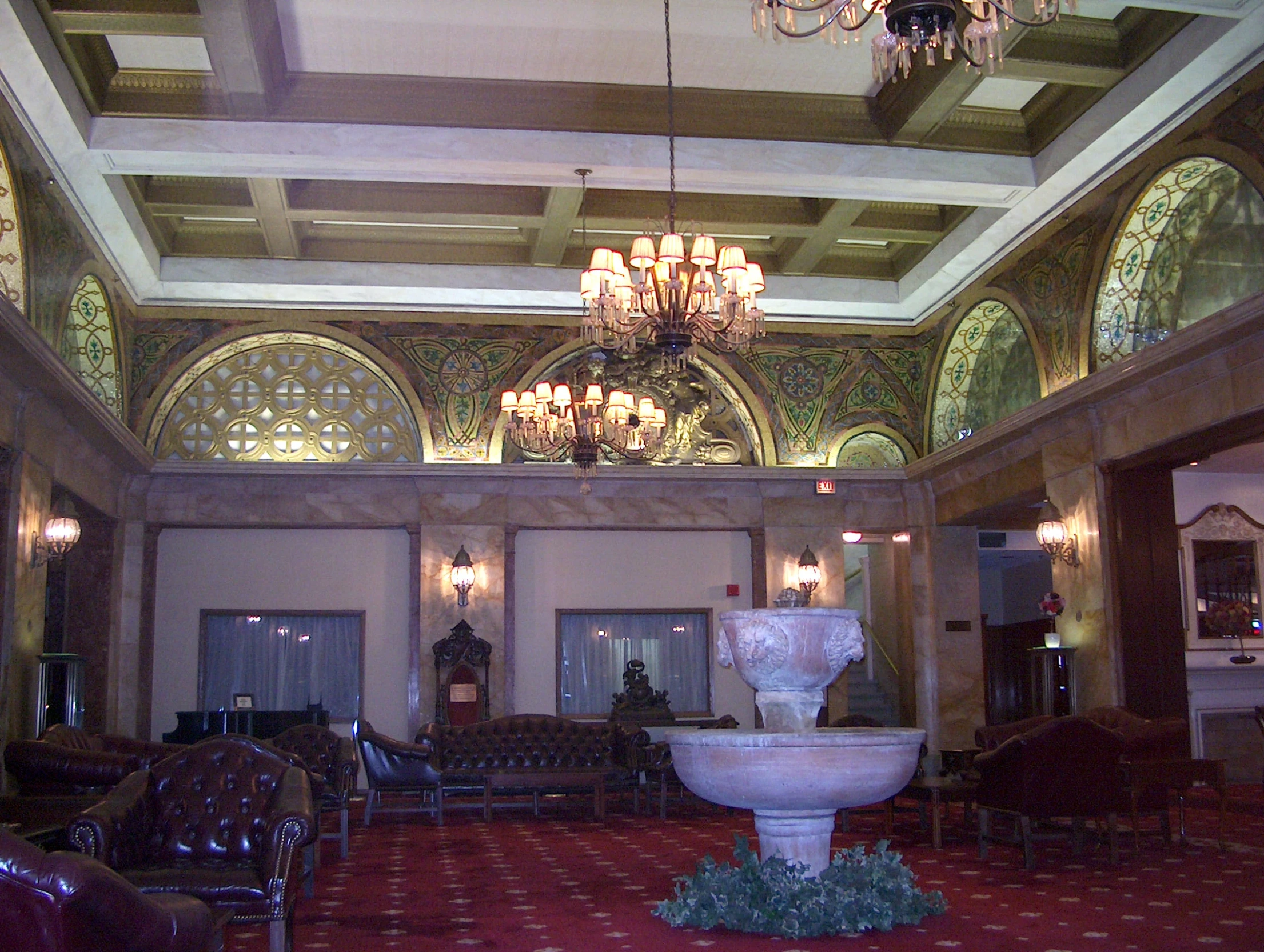 an ornately designed lobby features chandelier, chairs and a fountain