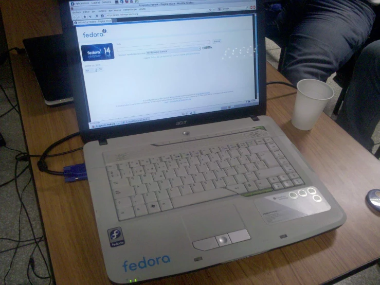 a laptop computer sitting on top of a wooden desk