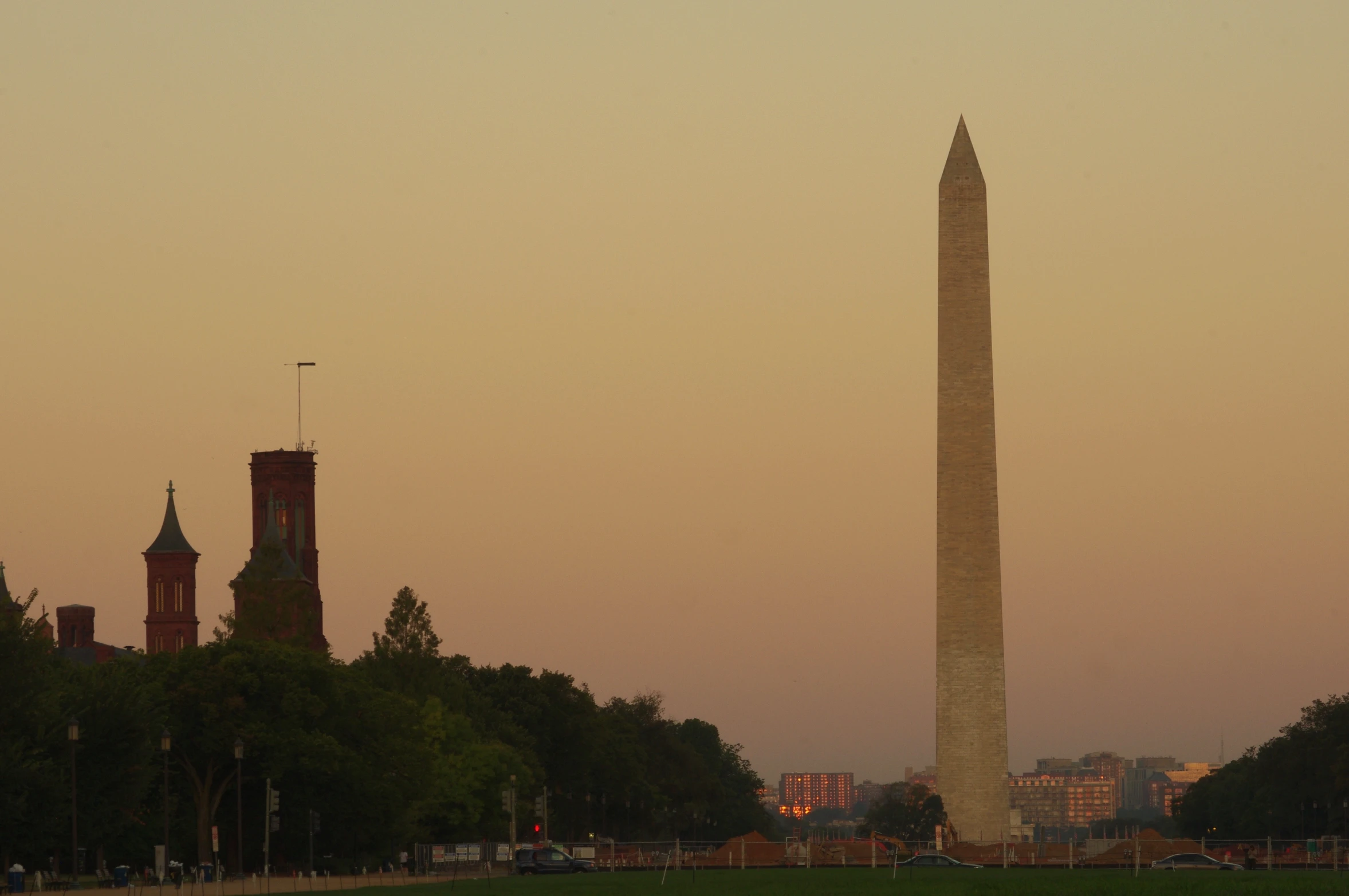 a large obelisk with an american flag near it