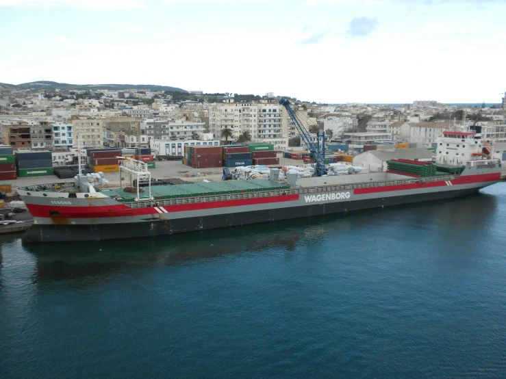 a large boat sailing in the water near many buildings