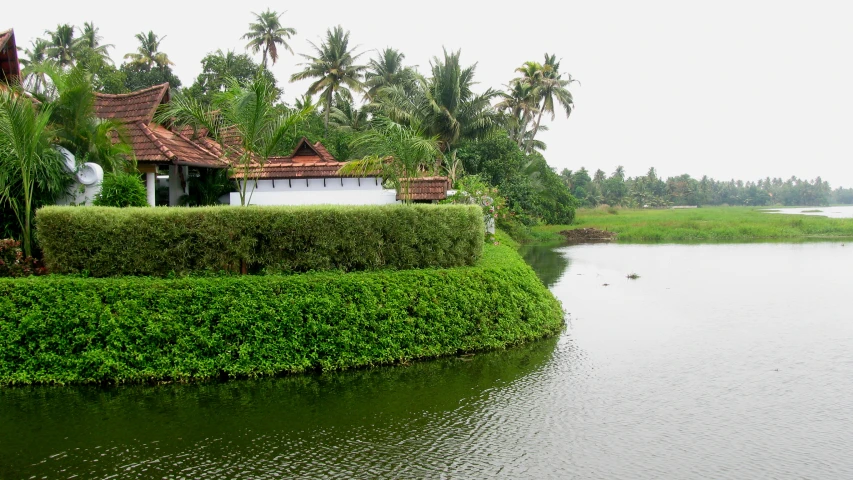 a pond and a house on the shoreline