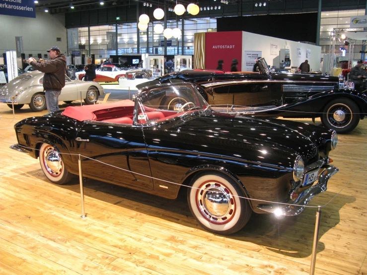 a group of old fashioned cars are on display