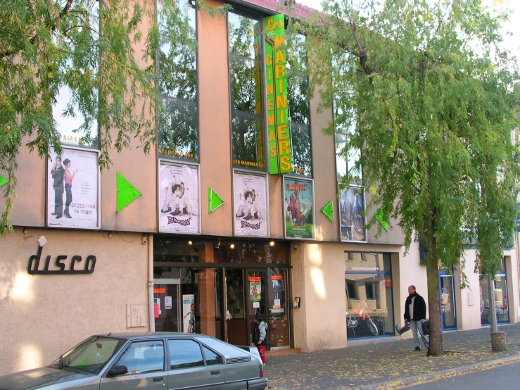 the building is near a busy street with cars parked in front