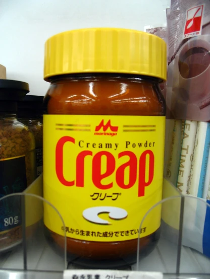 a jar of creap on display behind glass shelves