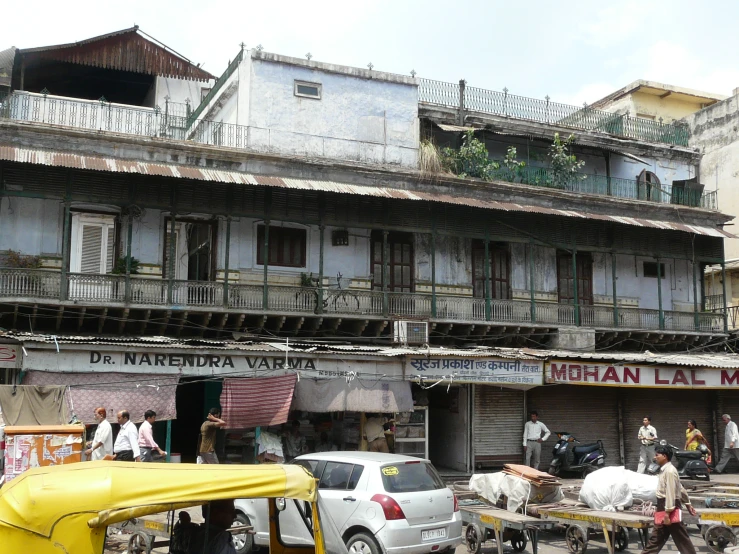 a city street with people, vehicles and buildings