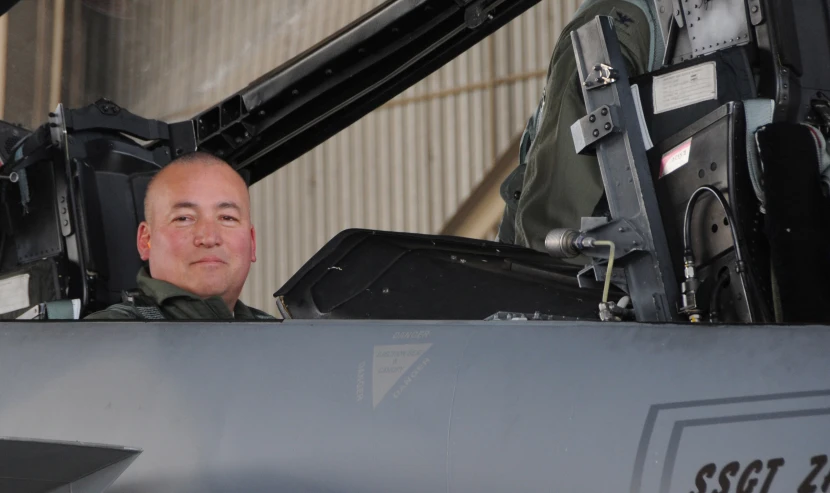 a man in an aircraft looking out from the cockpit