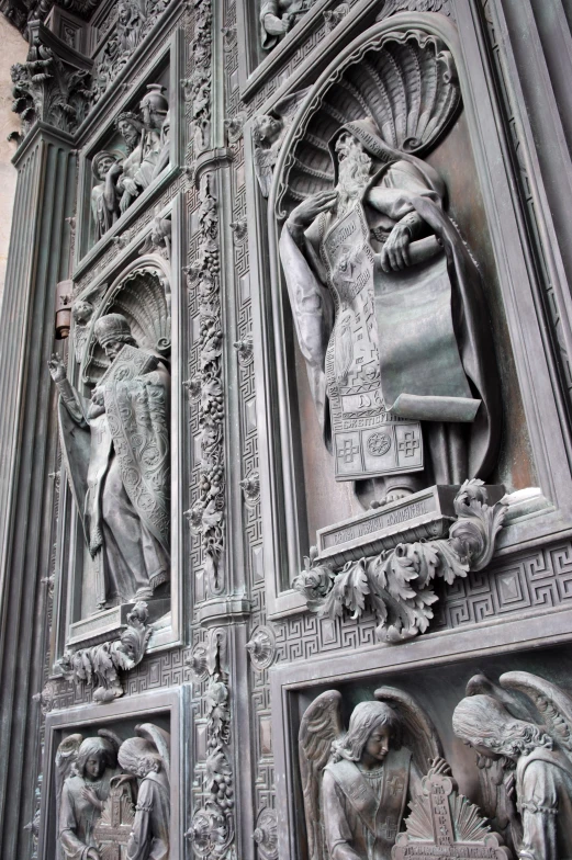 an intricately carved metal door with sculptures on it