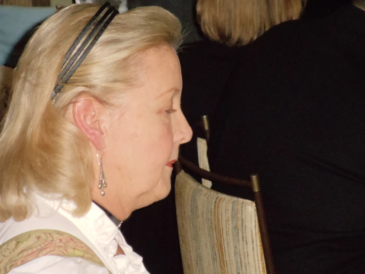 woman sitting in chair looking at cell phone