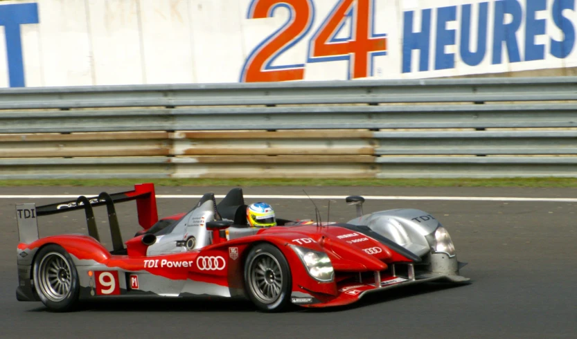 a racing car on the road with numbers 24 on it