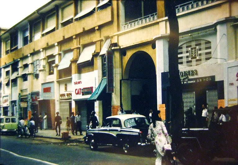 old fashion cars are parked on a city street