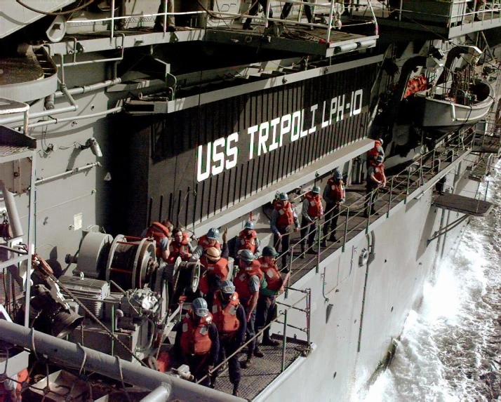 a large us navy ship filled with workers