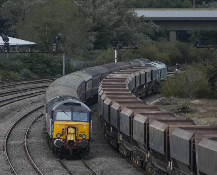 a train engine pulling carts down the tracks