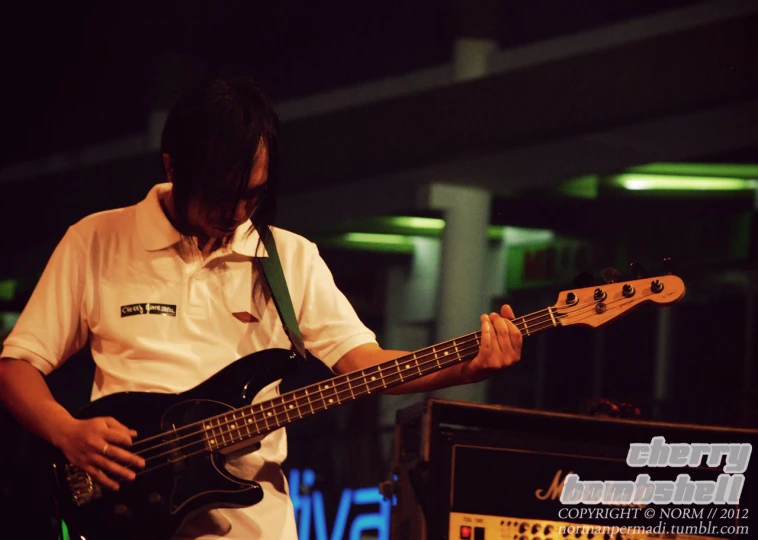 a man playing bass with two speakers on either side