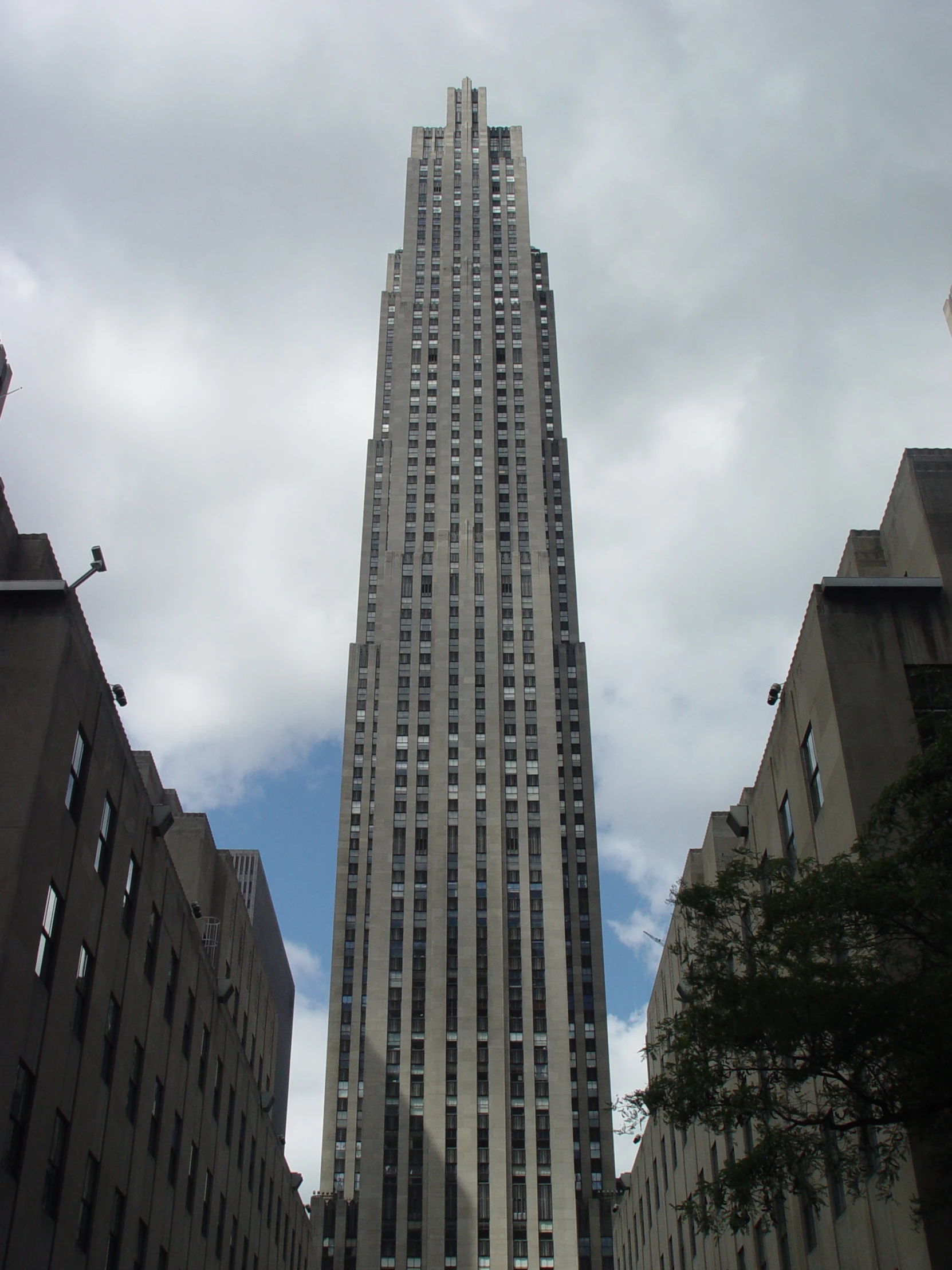 the very tall building is located between some other buildings