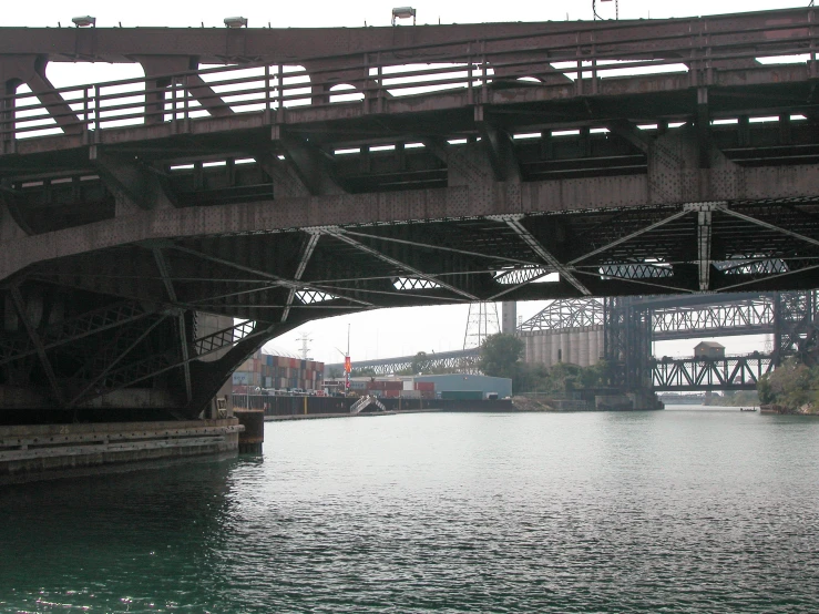bridge overlooking a body of water with large structures over it