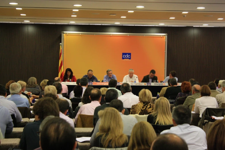 a group of people sitting in chairs at a conference