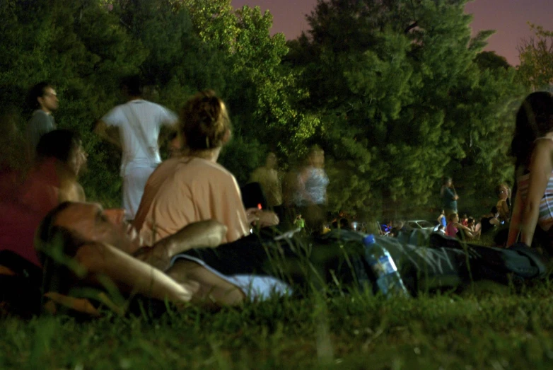 group of people relaxing in the sun on the park