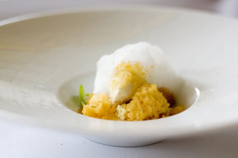 a dessert in a white bowl on a plate