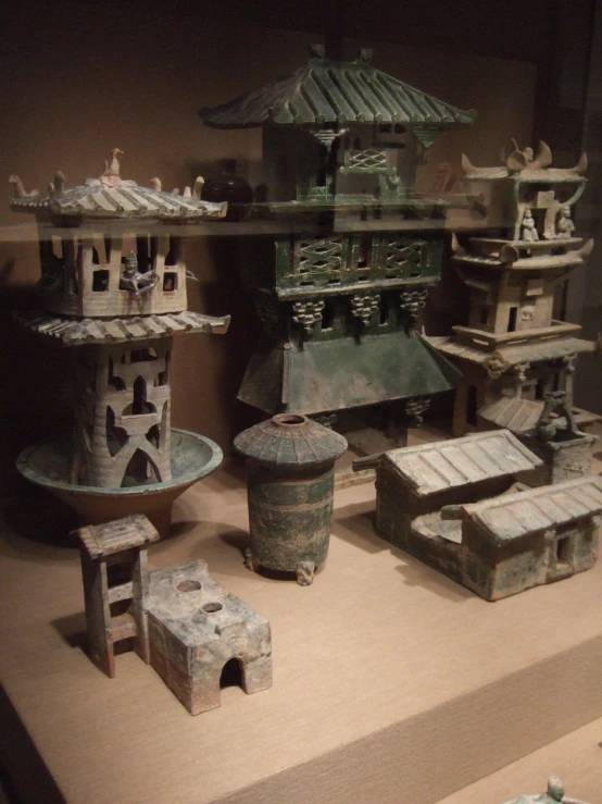 a display case with clay buildings and artifacts