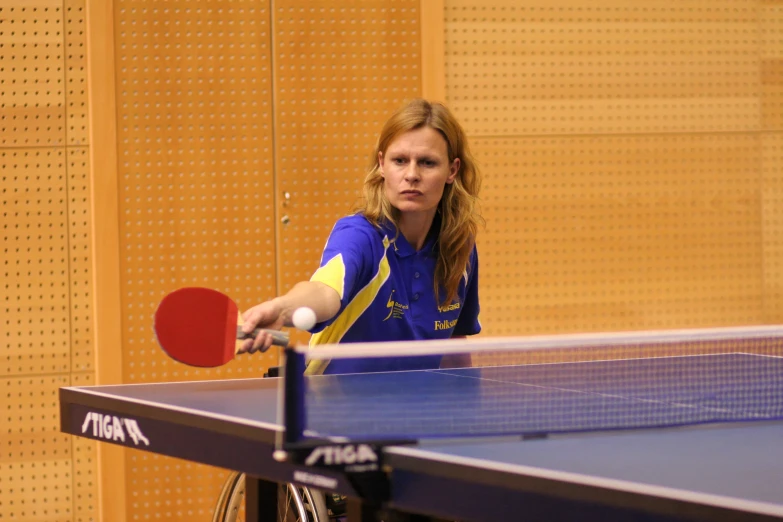 a woman with a paddle playing table tennis