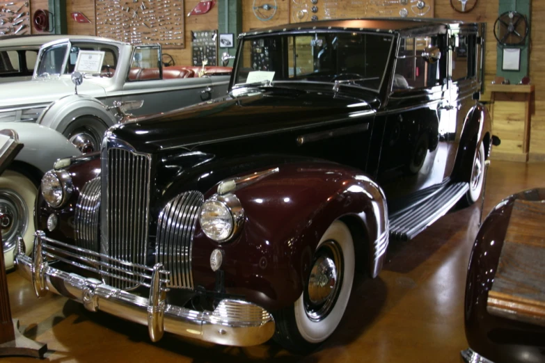 a black old style car is parked inside