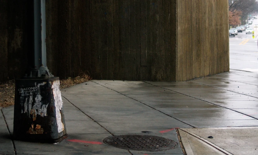 a public restroom on the sidewalk in a rainy day