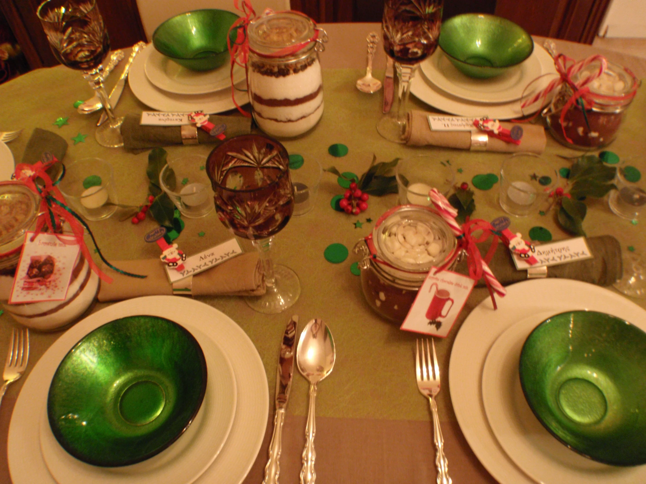 the christmas table is set with green plates