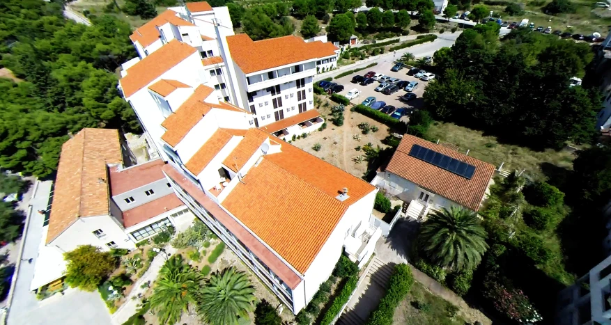 the top view of a residential building near the road