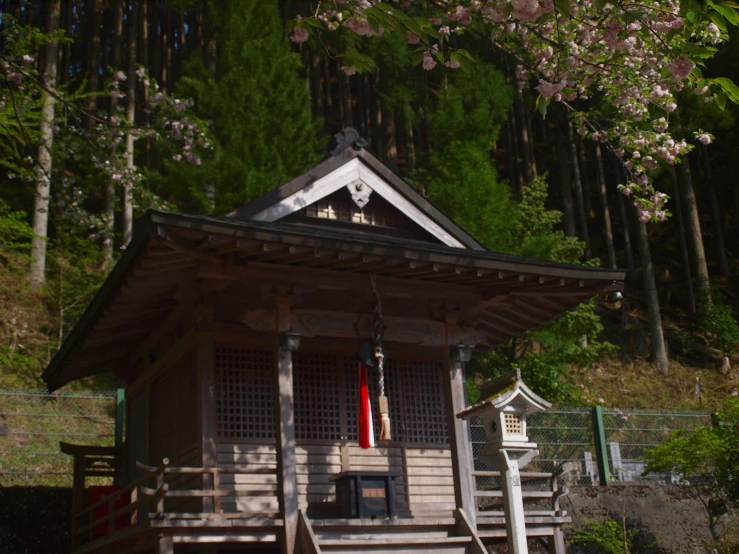 a small wooden structure with steps and a flag hanging out of it