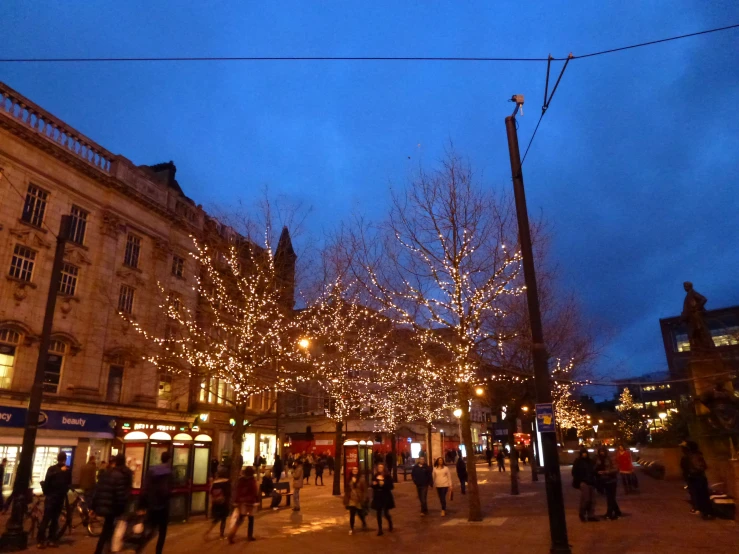 a lot of people walking down a street