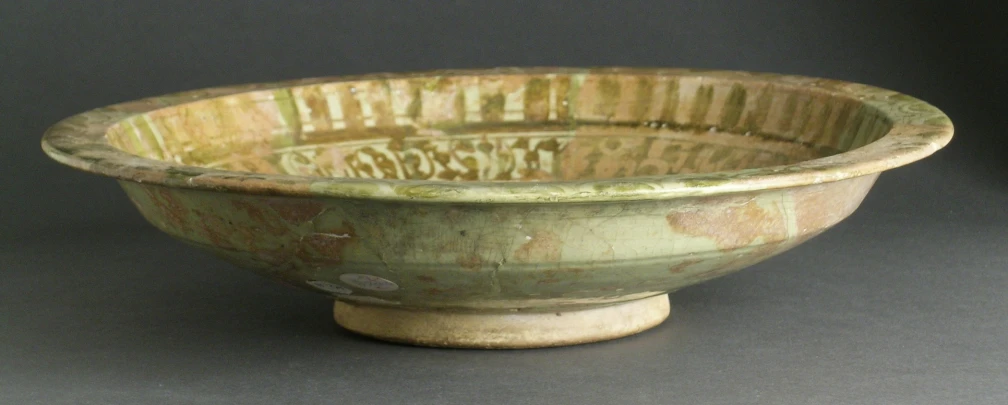 a brown stoneware bowl on grey background