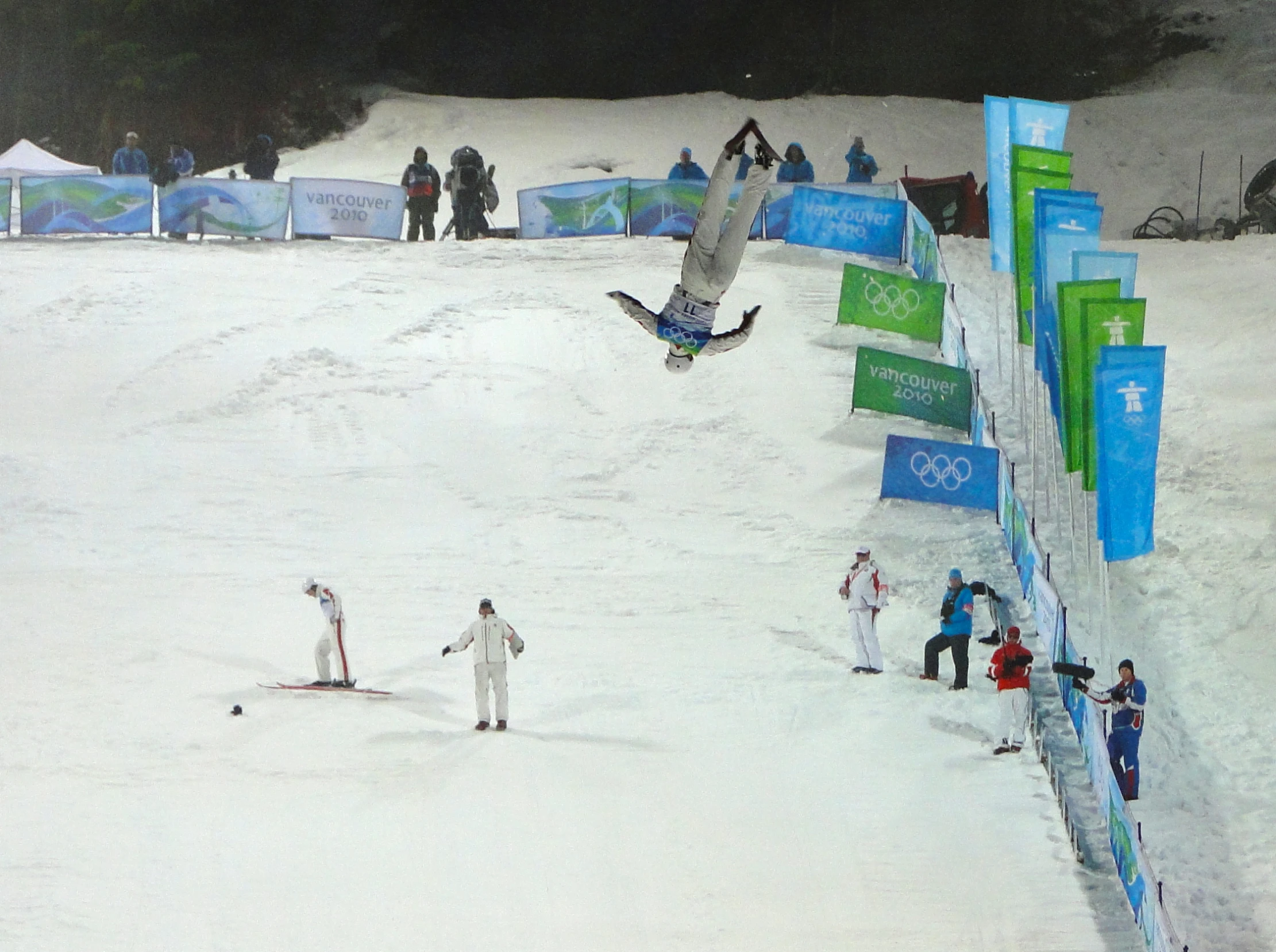 some snow skiers and snowboarders on a snow hill