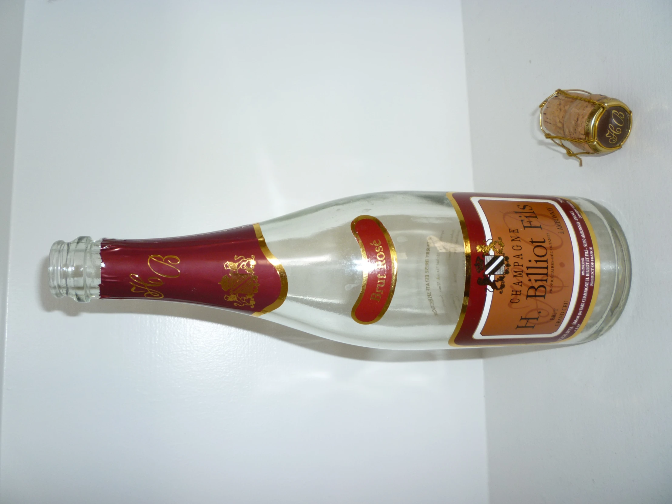 an empty wine bottle and a gold - colored object