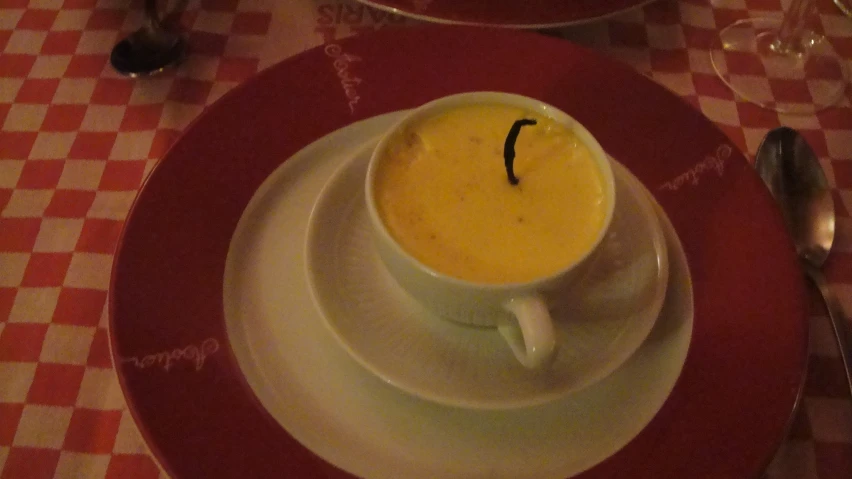 a bowl of soup with a spoon in it on a table