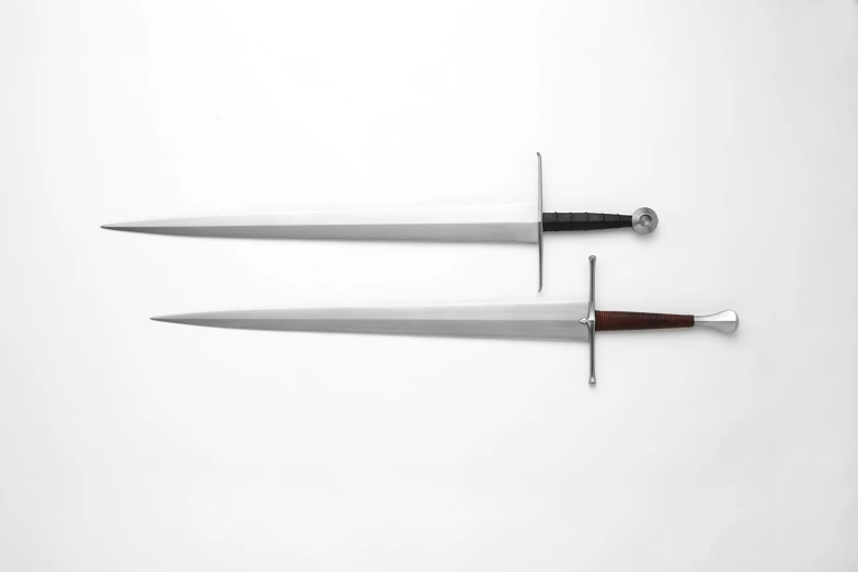 two long knives, one with black handles and the other red handle, placed next to each other