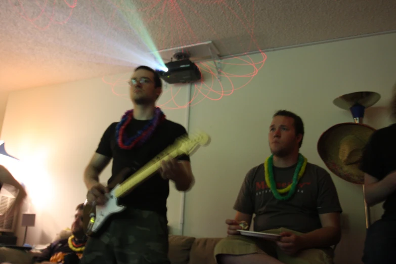 two men wearing leis and a green string