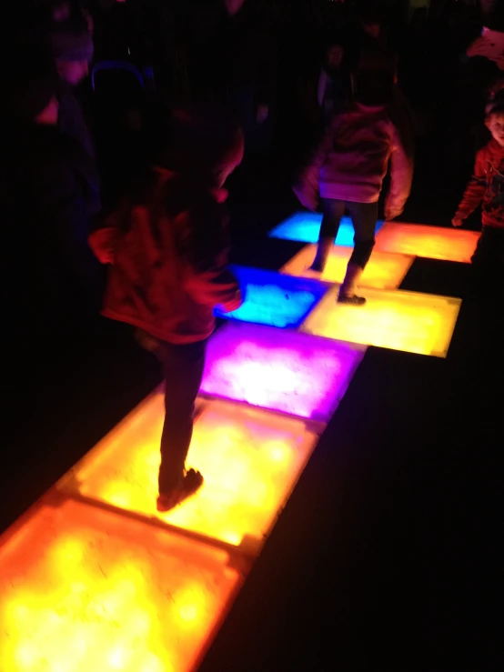 a group of people standing around in the dark