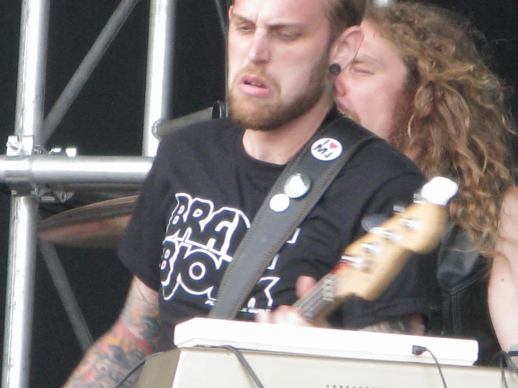 a man with a guitar in his hand at a stage