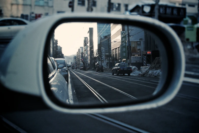 a rear view mirror sitting on the side of a road