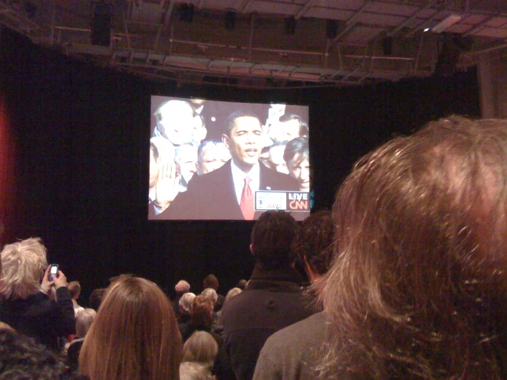 an image of a big screen on a crowded room