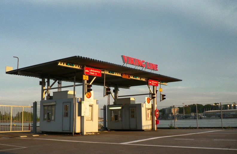 an empty gas station with a sky background