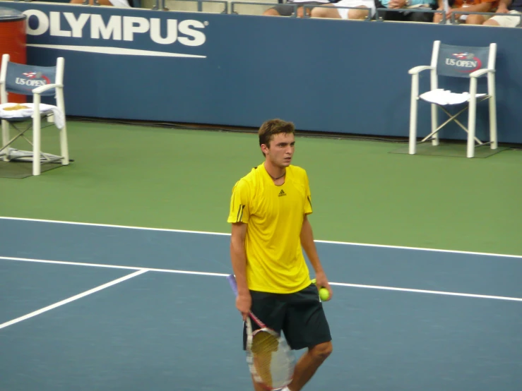 a tennis player in a yellow shirt is on the court