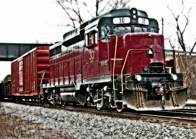 a train traveling down railroad tracks near trees