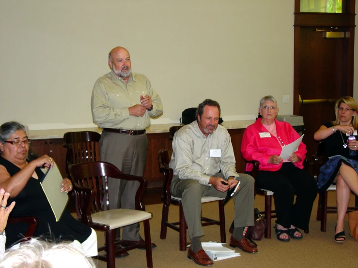 an image of a person speaking with a group