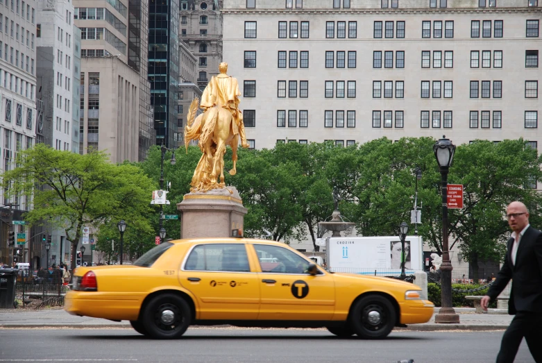 an image of taxi cab with statue in the back