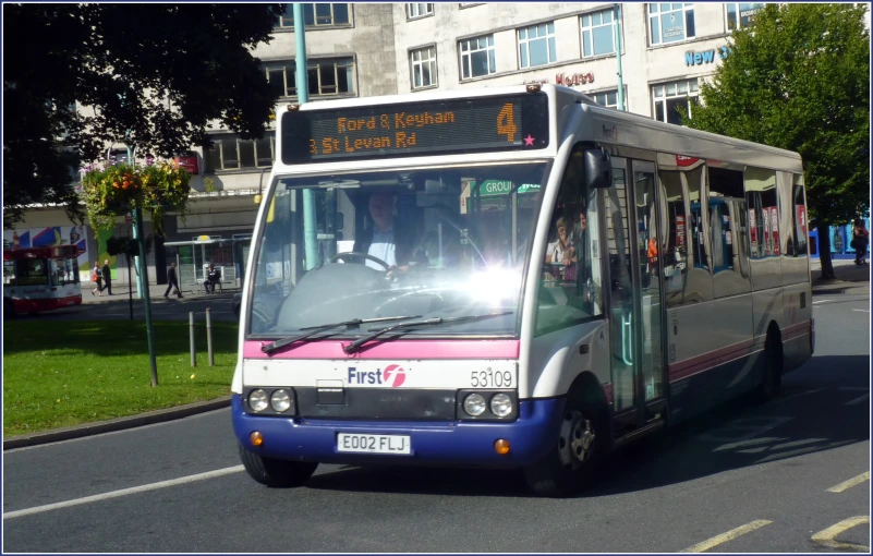 an image of a city bus driving down the street